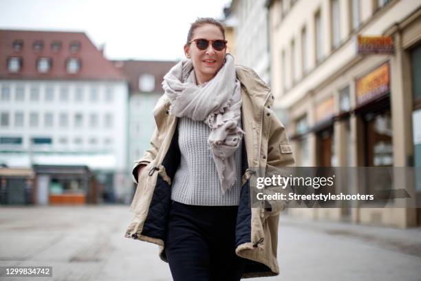 Fashion designer Eva Lutz wearing a beige jacket by Balenciaga, black pants by Balenciaga, a grey knitted pullover, a grey scarf by Pur schoen and...