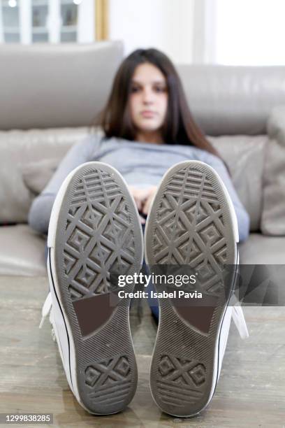 young woman resting on sofa. perspective from feet - girl soles stock pictures, royalty-free photos & images