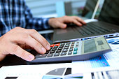 Businessman / accountant is doing calculations. Tax season.