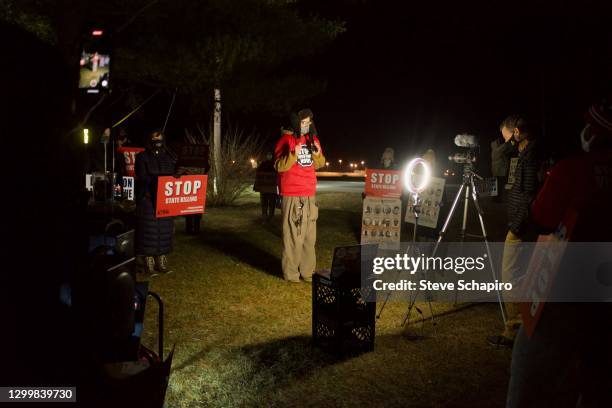 View of American religious activist and author Shane Claiborne as he speaks to a camera during an anti-death penalty rally, Terre Haute, Indiana,...