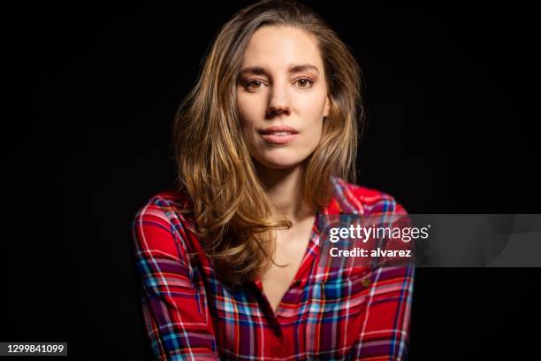 pretty young woman on black background - woman portrait plain background stock pictures, royalty-free photos & images