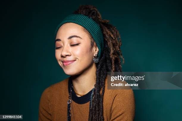 woman with eyes closed and smiling - satisfaction faces stock pictures, royalty-free photos & images