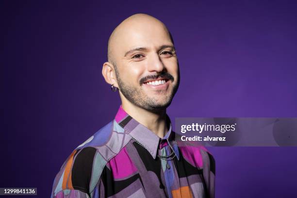 stylish man with clean shaved head - portrait studio purple background stock pictures, royalty-free photos & images