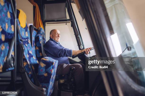 senior male driver driving bus - bus driver stock pictures, royalty-free photos & images