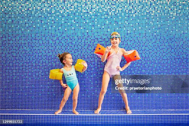 porträt der kleinen mädchen in einem schwimmbad - kids pool games stock-fotos und bilder