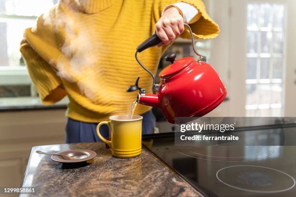 woman preparing a tea - boiling water stock pictures, royalty-free photos & images