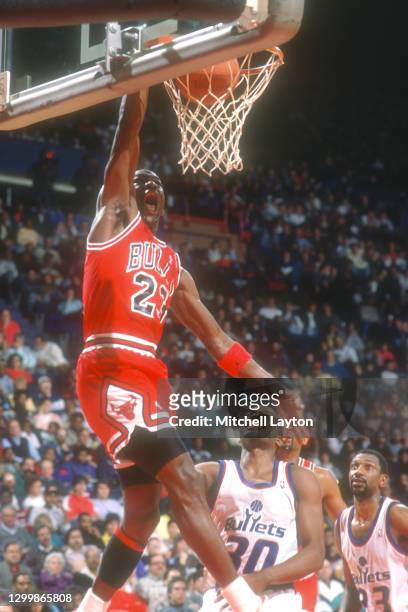 Michael Jordan of the Chicago Bulls dunks the ball during a NBA basketball game against the Washington Bullets at the Capital Centre on December 14,...