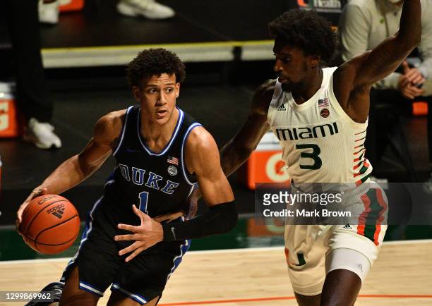 Jalen Johnson of the Duke Blue Devils drives to the basket against Nysier Brooks of the Miami Hurricanes during the first half at Watsco Center on...