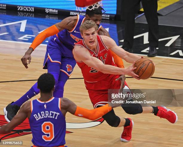 Lauri Markkanen of the Chicago Bulls drives between RJ Barrett and Nerlens Noel of the New York Knicks at the United Center on February 01, 2021 in...