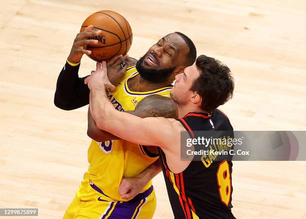 LeBron James of the Los Angeles Lakers draws a foul from Danilo Gallinari of the Atlanta Hawks during the second half at State Farm Arena on February...