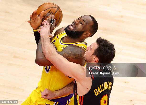 LeBron James of the Los Angeles Lakers draws a foul from Danilo Gallinari of the Atlanta Hawks during the second half at State Farm Arena on February...