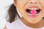 Little girl eating candy and sugar with bad oral hygiene and cavity. Teeth dental care.