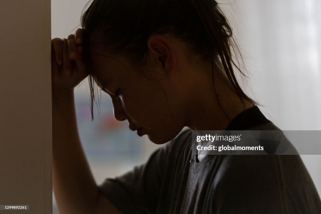 Sadness and depression. Women stressed out at home.