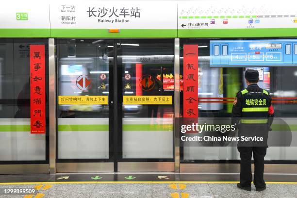 Pair of Spring Festival couplets are seen on the platform screen door of a metro station to welcome the upcoming Chinese New Year, the Year of the...