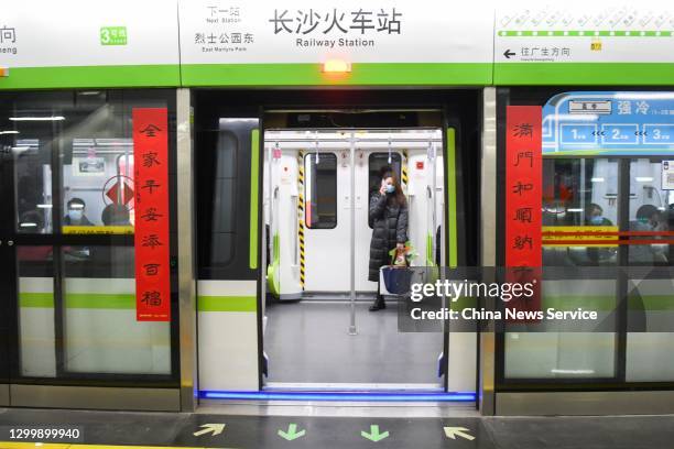 Pair of Spring Festival couplets are seen on the platform screen door of a metro station to welcome the upcoming Chinese New Year, the Year of the...