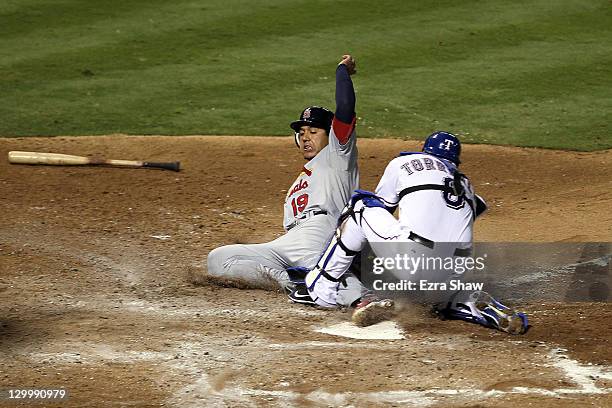 Yorvit Torrealba of the Texas Rangers tags out Jon Jay of the St. Louis Cardinals at home plate in the fourth inning during Game Three of the MLB...