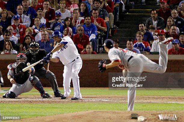 Nelson Cruz of the Texas Rangers hits a two-run home run in the fourth inning off of Kyle Lohse of the St. Louis Cardinals during Game Three of the...