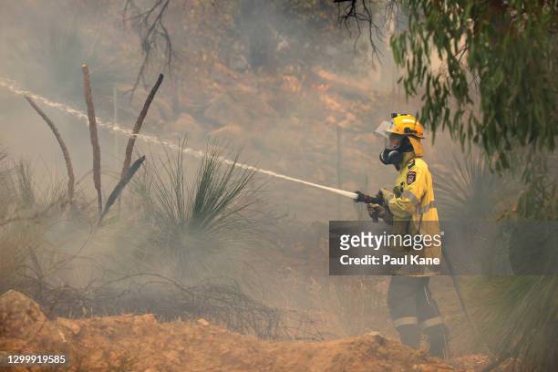Fire crews control bush fires as they approach properties on Copley Road in Upper Swan on February 02, 2021 in Perth, Australia. The Rapid Damage...