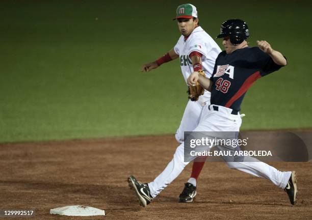 Mexican Agustin Murillo puts out James Gallagher from the USA during a baseball match of the Guadalajara 2011 XVI Pan-American Games in Lagos de...