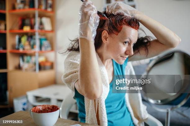 woman dyeing her own hair at home - dye stock pictures, royalty-free photos & images