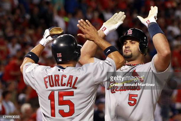 Rafael Furcal and Albert Pujols of the St. Louis Cardinals celebrate after scoring on a Pujols three-run home run in the sixth inning during Game...