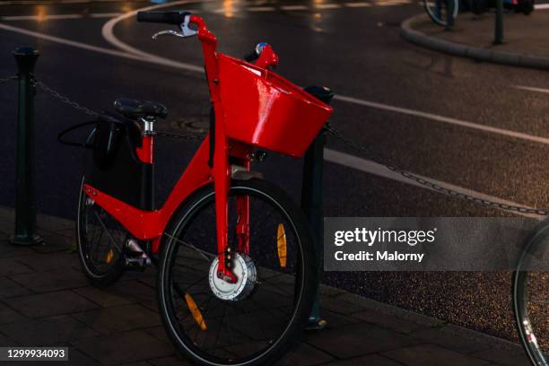 public transportation. e-bike standing on the side of a city street. - glow düsseldorf stock-fotos und bilder