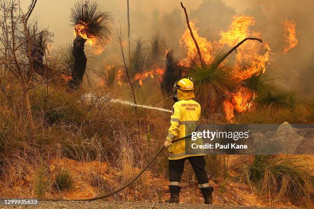 Fire crews control bush fires as they approach properties on Copley Road in Upper Swan on February 02, 2021 in Perth, Australia. The Rapid Damage...