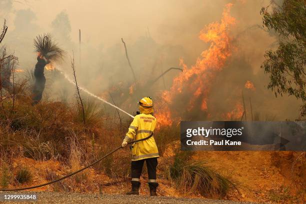 Fire crews control bush fires as they approach properties on Copley Road in Upper Swan on February 02, 2021 in Perth, Australia. The Rapid Damage...