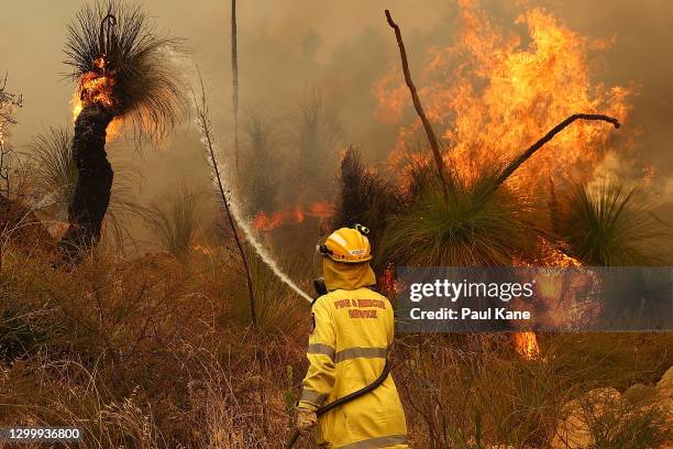 Fire crews control bush fires as they approach properties on Copley Road in Upper Swan on February 02, 2021 in Perth, Australia. The Rapid Damage...