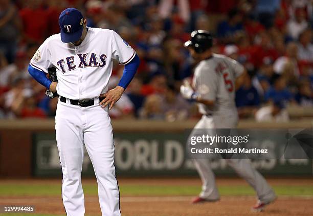 Mike Gonzalez of the Texas Rangers reacts as Albert Pujols of the St. Louis Cardinals rounds the bases after hitting a two-run home run in the...