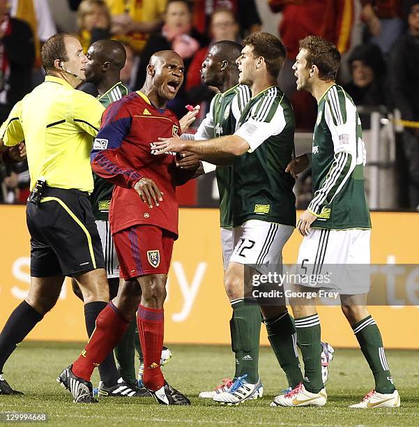 Jamison Olave of Real Salt Lake confronts David Horst and Eric Brunner of Portland Timbers during the second half of an MLS soccer game October 22,...