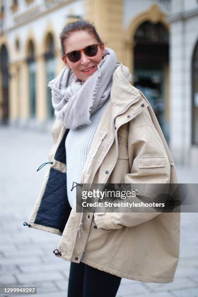 Fashion designer Eva Lutz wearing a beige jacket by Balenciaga, a grey knitted pullover, a grey scarf by Pur schoen and brown vintage sunglasses...