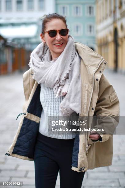 Fashion designer Eva Lutz wearing a beige jacket by Balenciaga, a grey knitted pullover, a grey scarf by Pur schoen and brown vintage sunglasses...