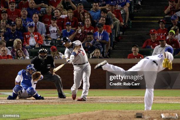 Albert Pujols of the St. Louis Cardinals hits a solo home run in the ninth inning for his third home run of the night during Game Three of the MLB...