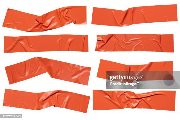 orange colored plastic adhesive tape stripes - tape foto e immagini stock