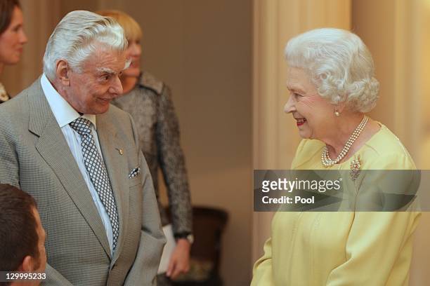 Queen Elizabeth II speaks with race horse trainer Bart Cummings at the Governor Generals Lunch on October 23, 2011 in Canberra, Australia. The Queen...