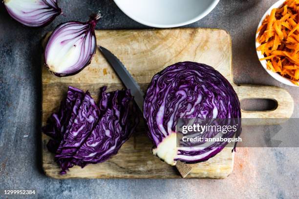 fresh carrot, cabbage and red onions on a chopping board - purple cabbage stock pictures, royalty-free photos & images