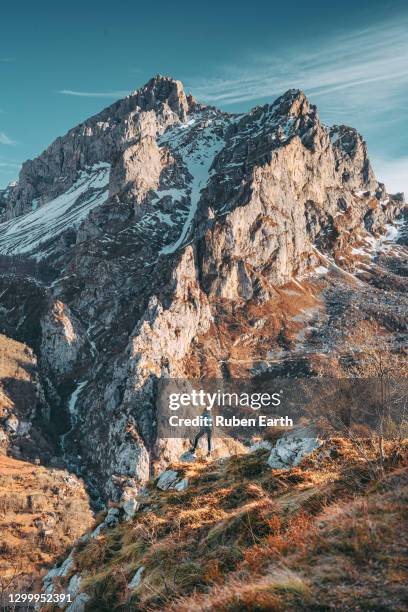 womain hiking with a backpack looking at the mountains and landscape - picos de europe stock pictures, royalty-free photos & images