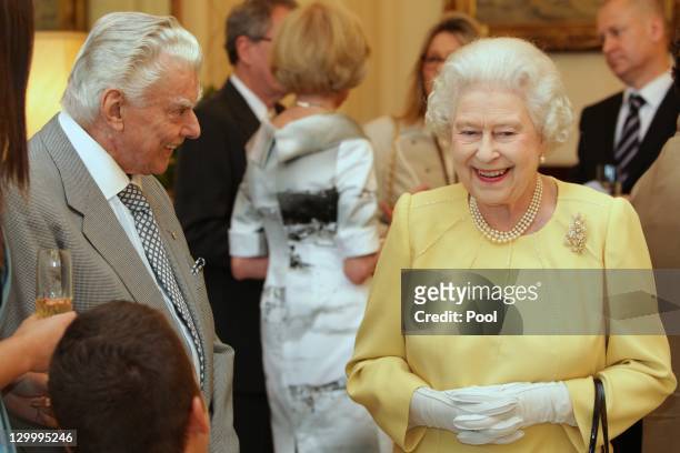 Queen Elizabeth II speaks with race horse trainer Bart Cummings at the Governor Generals Lunch on October 23, 2011 in Canberra, Australia. The Queen...