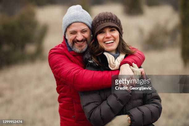 happy mature couple - mature couple winter outdoors stock pictures, royalty-free photos & images