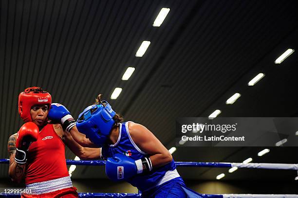 Erika Cruz of Mexico fights against Adriana Araujo of Brazil during the Woman's Light Welter 57-60 kg in the 2011 XVI Pan American Games at the Arena...