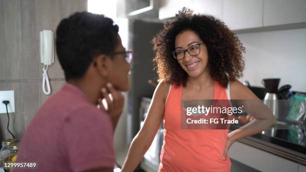 son talking to mother at home (or complaining about sore throat) - amygdala stock pictures, royalty-free photos & images