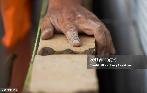 bricklayer installing bricks - brick layer stock-fotos und bilder