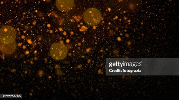 orange defocused lights and particles - lense flare stock-fotos und bilder