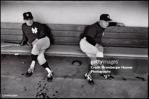 American baseball coaches Yogi Berra and Don Zimmer , both of the New York Yankees sit on a bench in a dugout at the Oakland Coliseum, Oakland,...