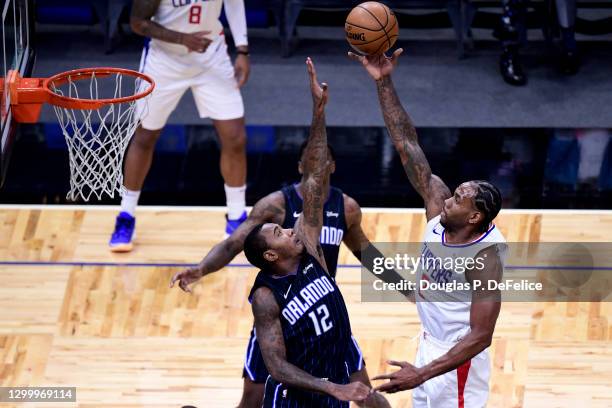 Kawhi Leonard of the LA Clippers looks to shoot the ball as Gary Clark of the Orlando Magic defends during the third quarter at Amway Center on...