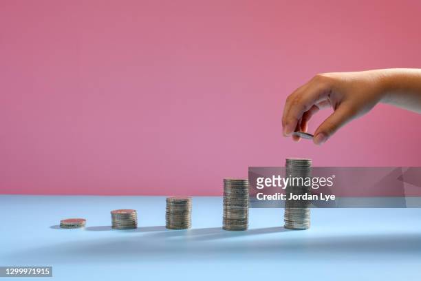 money coins arranged as a graph - euro in hand stock pictures, royalty-free photos & images