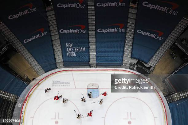 Advertisements cover spectators seating as Alex Ovechkin of the Washington Capitals and Brad Marchand of the Boston Bruins battle for the puck at...