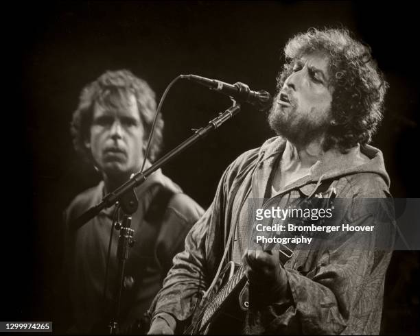 American Folk and Rock musician Bob Dylan plays guitar as he performs with Bob Weir, of the group the Grateful Dead, onstage at the Oakland Coliseum,...