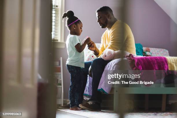 father and daughter talking in bedroom at home - stay at home saying stock pictures, royalty-free photos & images